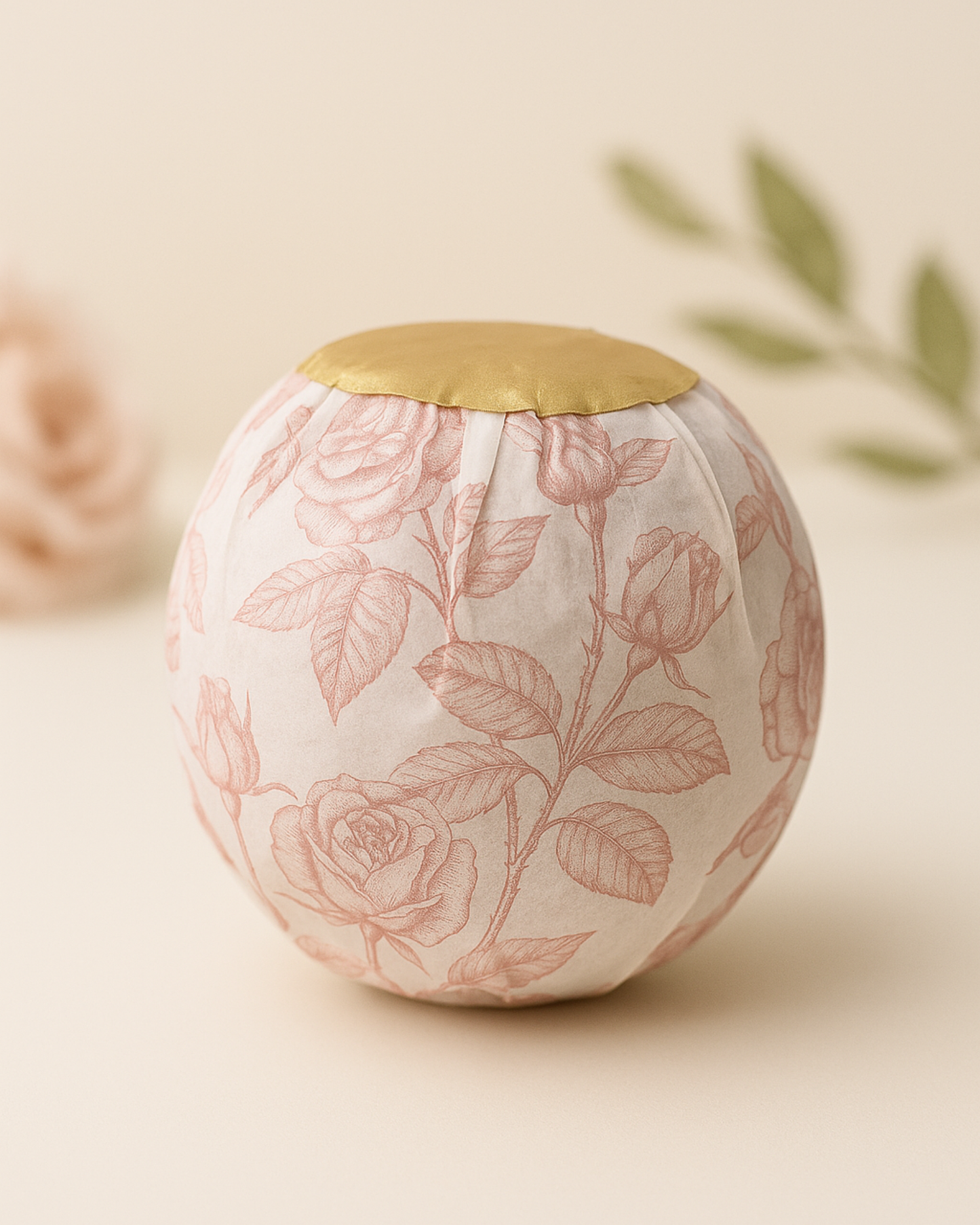 Aphrodite’s Sphere by DEOS Co. — a luxury rose bath bomb wrapped in vintage floral paper with gold detailing, crafted for a refined spa experience.