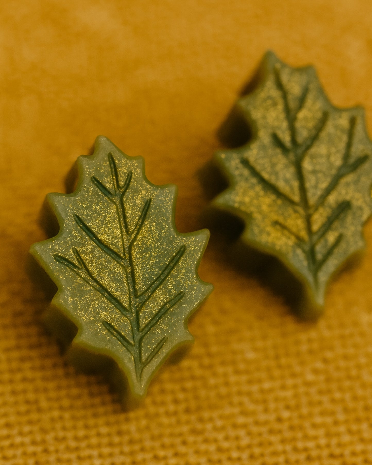Handcrafted Elysian Leaf Christmas soaps in rich green with gold accents — made from pure botanical oils and inspired by Greek nature, offering a clean, luxurious, and eco-conscious touch