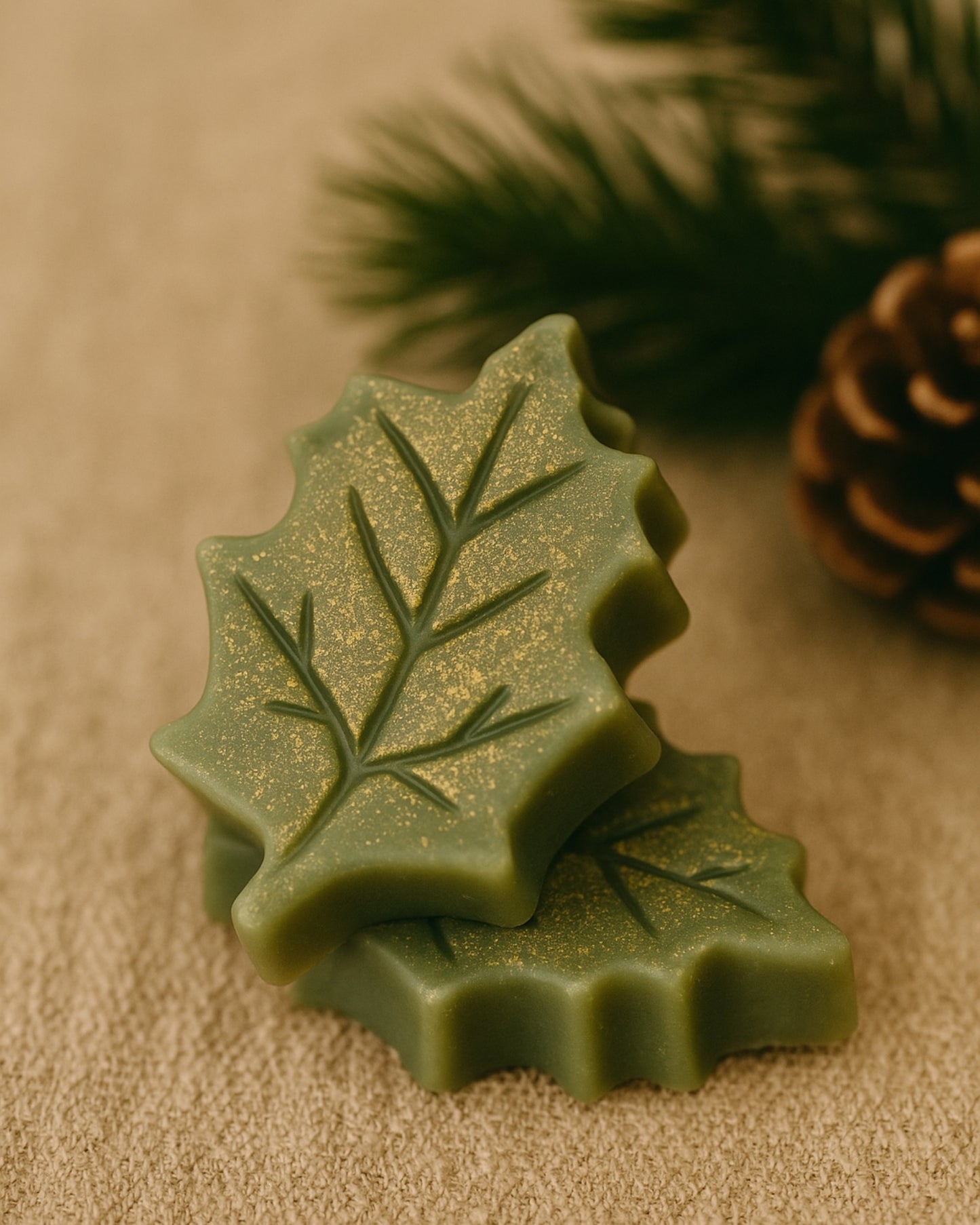 Elegant duo of Elysian Leaf botanical soaps inspired by Greek nature — handcrafted with pine and orange essential oils, creating a festive natural glow with golden shimmer and artisanal detail