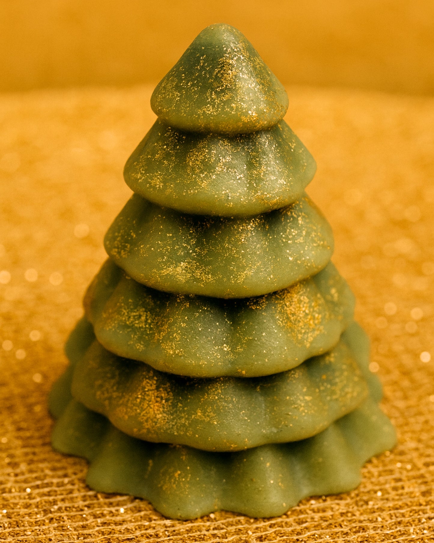 Close-up of DEOS Co. Olympian Pine handmade soap — a luxury Christmas tree design with pine and orange essential oils, French green clay, and golden shimmer, made in Greece.
