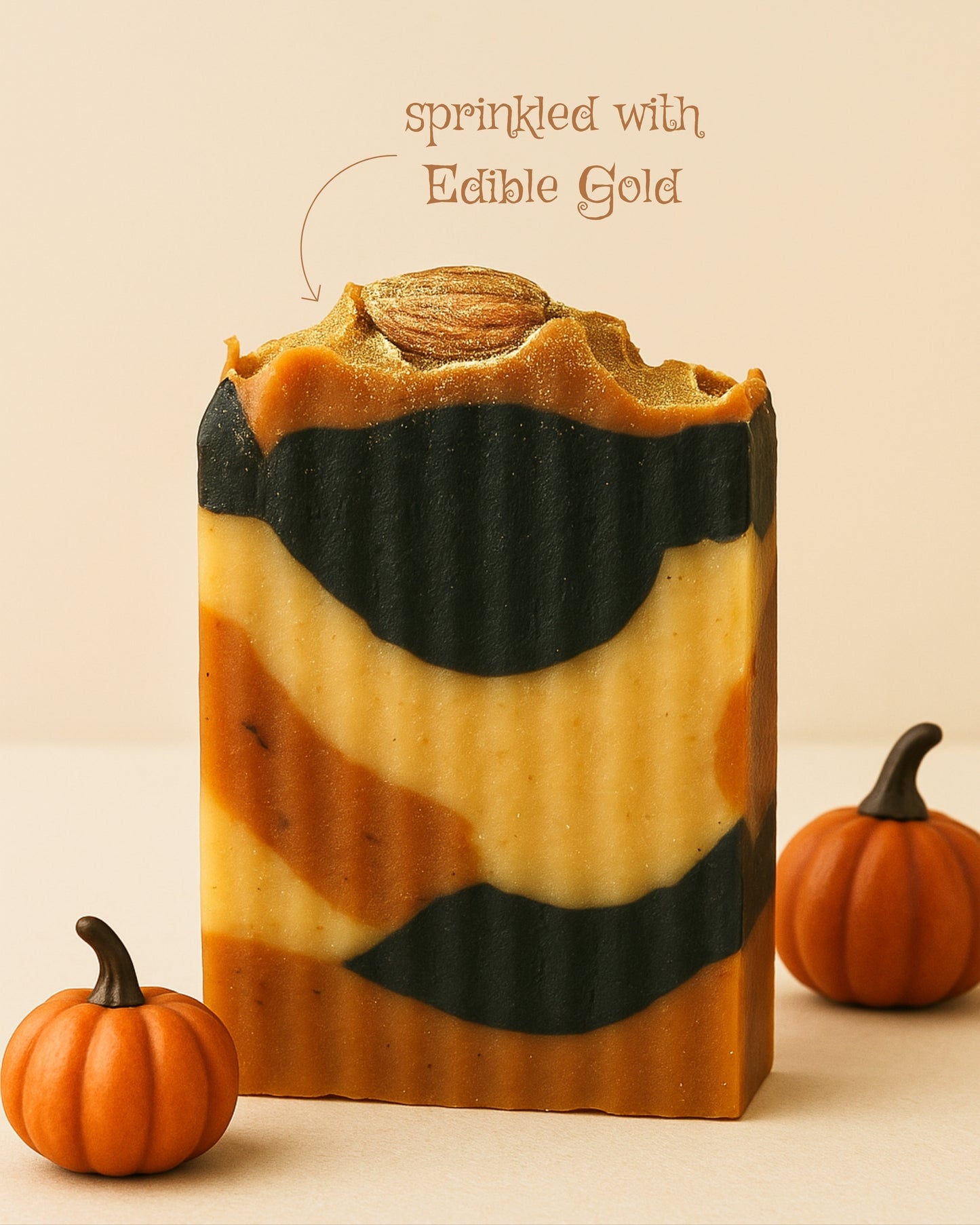 Bar of soap with pumpkin design and small pumpkins on a beige background by DEOS Co. soap brand