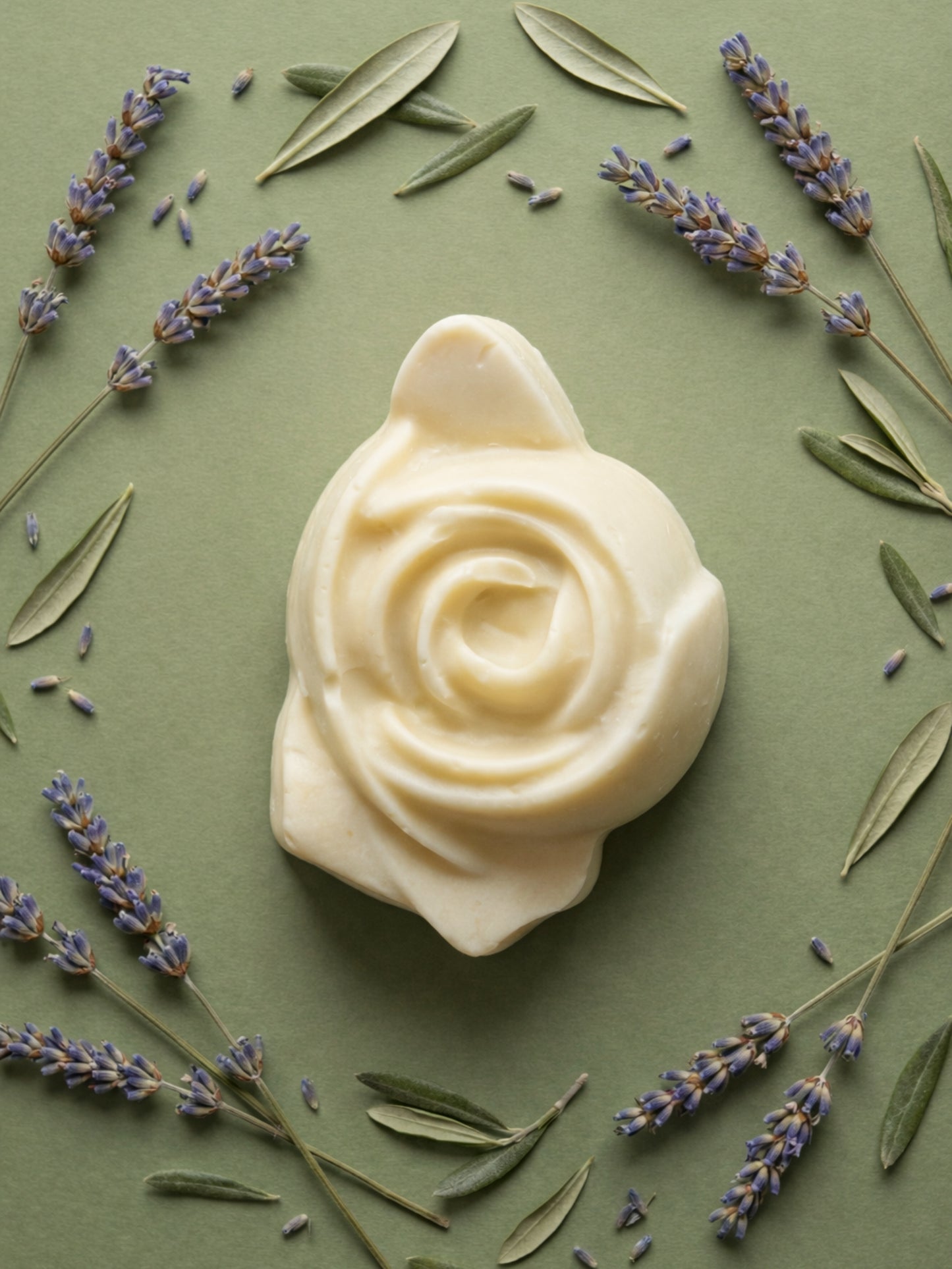 The Anthéa by DEOS CO., an ivory rose-shaped bar soap made from pure olive oil, surrounded by lavender