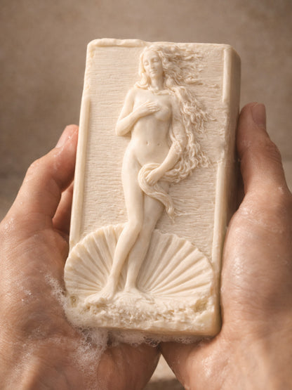 Hand-held rectangular olive oil soap featuring Aphrodite relief, showing size and sculptural detail, natural lavender soap by DEOS Co.