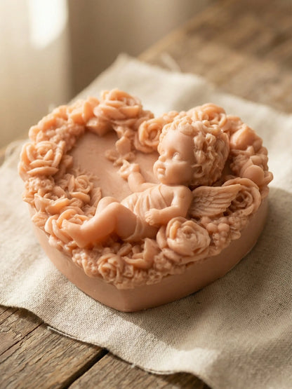 Heart-shaped Eros Angel soap resting on linen fabric, natural Rose Geranium & Vanilla soap from the Valentine’s Day Collection by DEOS CO