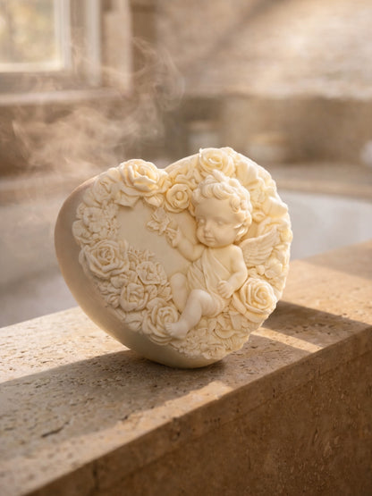 Heart-shaped soap with angel and floral design on a stone surface with steam in the background by DEOSCO. Greek Olive oil and lavender soap by DEOS Co.

The Eros Angel — Pure Olive Oil & Lavender Soap | Nardus Bliss Collection