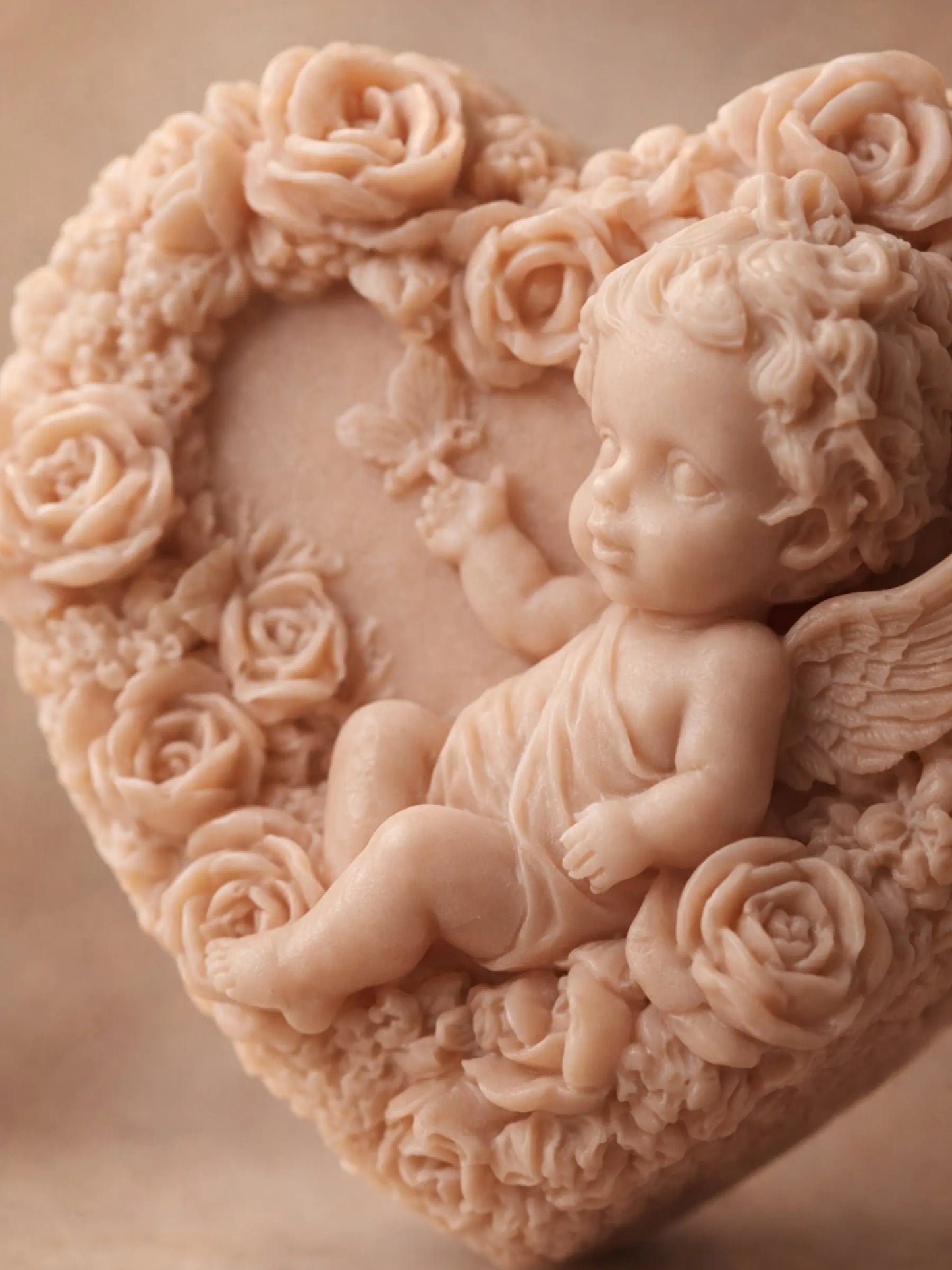 Close-up of Eros Angel heart soap showing detailed cherub sculpture and rose relief, handcrafted natural soap BY DEOS CO for Valentine's Day Collection