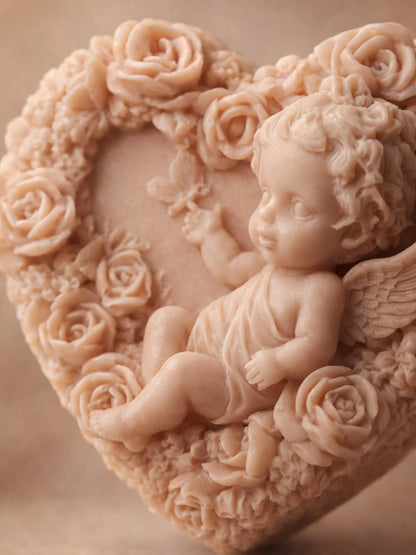Close-up of Eros Angel heart soap showing detailed cherub sculpture and rose relief, handcrafted natural soap BY DEOS CO for Valentine's Day Collection