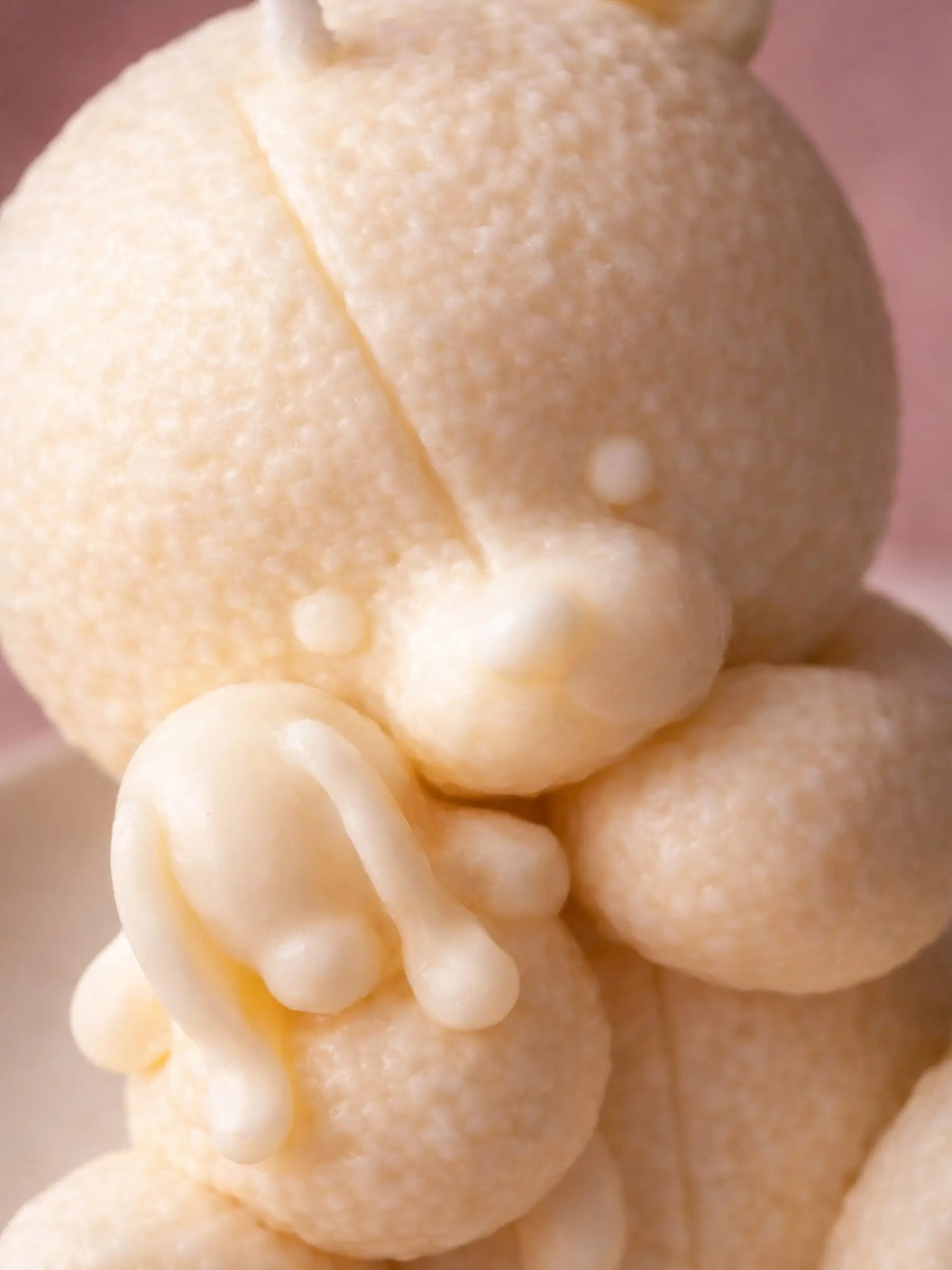 Close-up of handmade Elior soy teddy bear candle texture showing detailed wax craftsmanship by DEOS Co