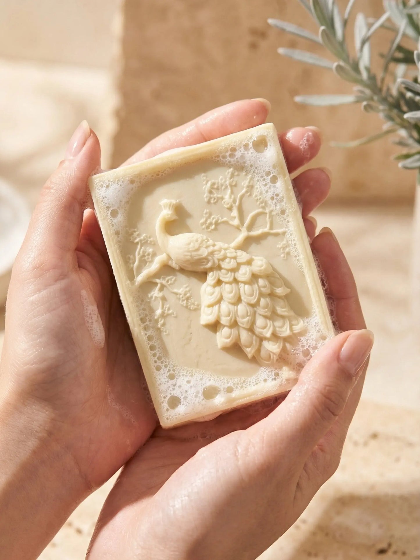Hand holding ARGEA peacock olive oil lavender soap, artisan Greek olive oil soap by DEOS Co.
