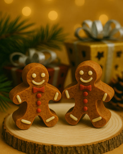 Golden Gingerbread Glow handmade Christmas soap bars by Deos Co., shaped like gingerbread men on a wooden base with warm festive lighting and luxury gift boxes in the background.