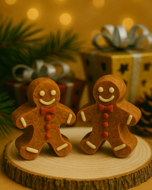 Golden Gingerbread Glow handmade Christmas soap bars by Deos Co., shaped like gingerbread men on a wooden base with warm festive lighting and luxury gift boxes in the background.