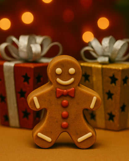 Single gingerbread man soap by Deos Co., handcrafted from organic olive oil and festive botanicals, displayed with golden Christmas glow and bokeh lights.