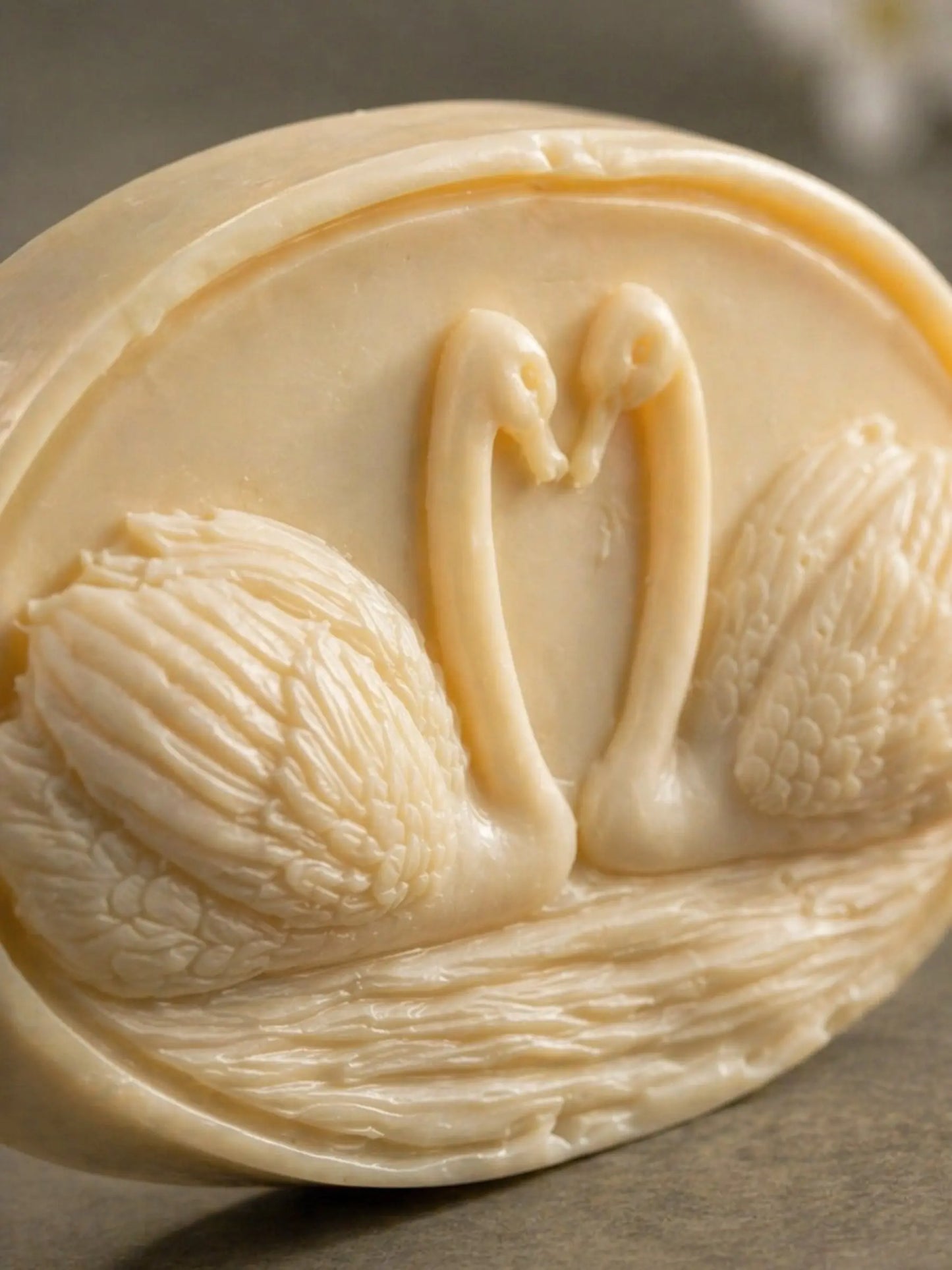 Close-up of swan carved jasmine olive oil soap, handcrafted botanical relief, premium natural soap by DEOS Co.
