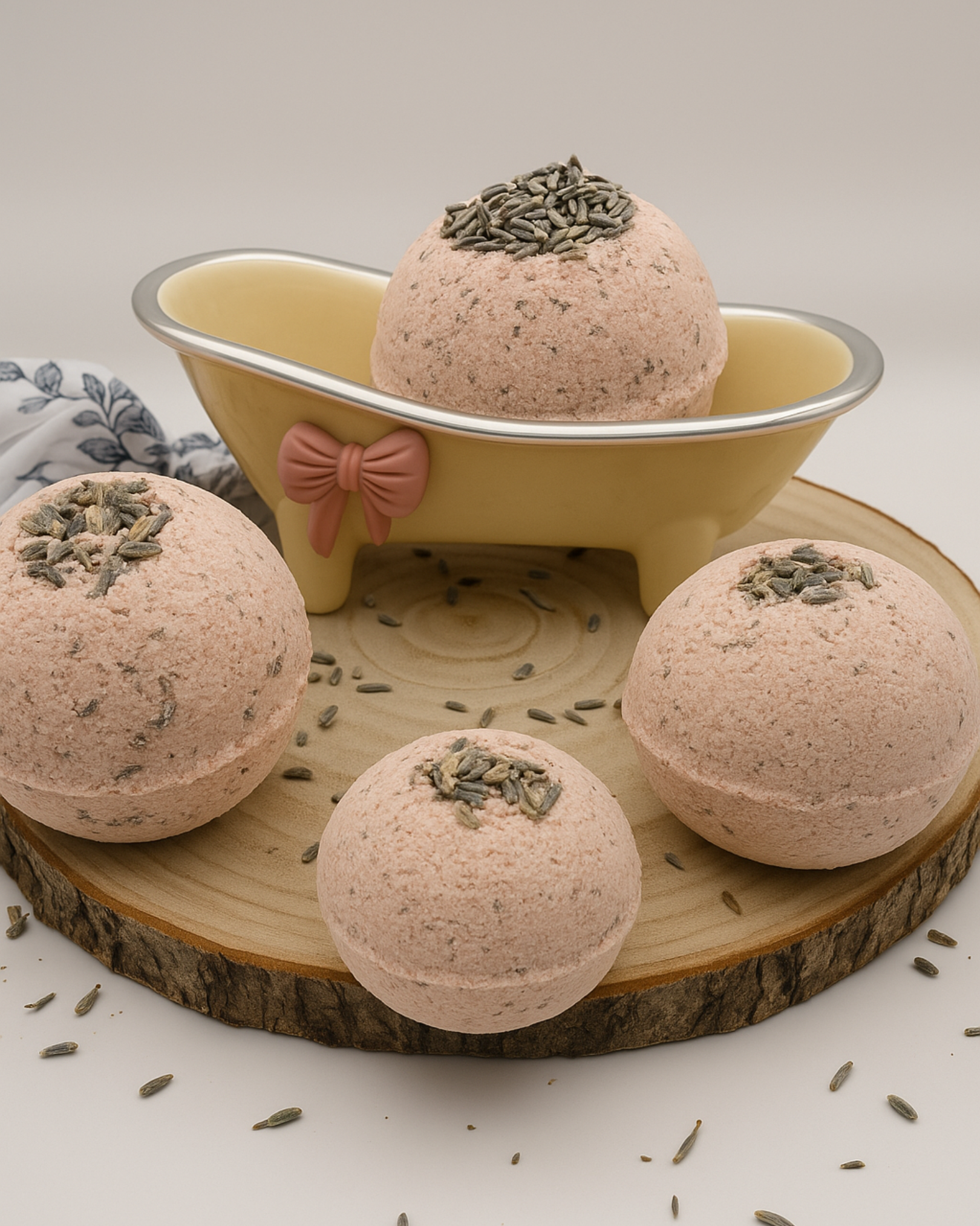 Nardus Sphere Lavender bath bombs with greenery on top on a wooden board with a small bathtub decoration by DEOS CO.