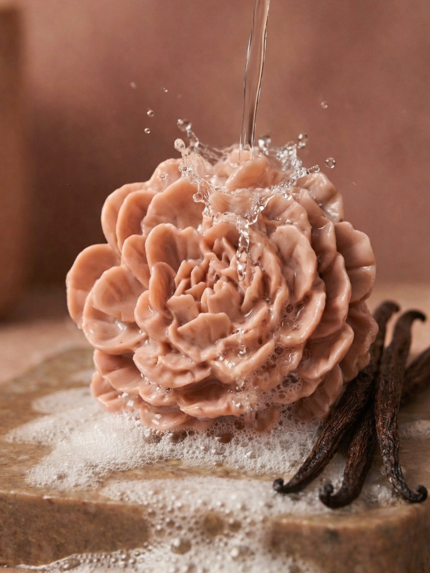 PEONÍA flower soap by DEOS Co., a Valentine’s Day rose geranium and vanilla bar with sculptural peony petals under running water with vanilla sticks