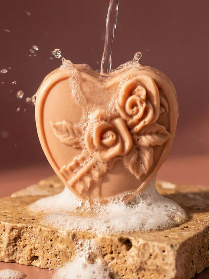 Rosea heart soap with carved rose detail under flowing water, handmade natural olive oil soap for Valentine’s Day by DEOS CO. with rose geranium and vanilla