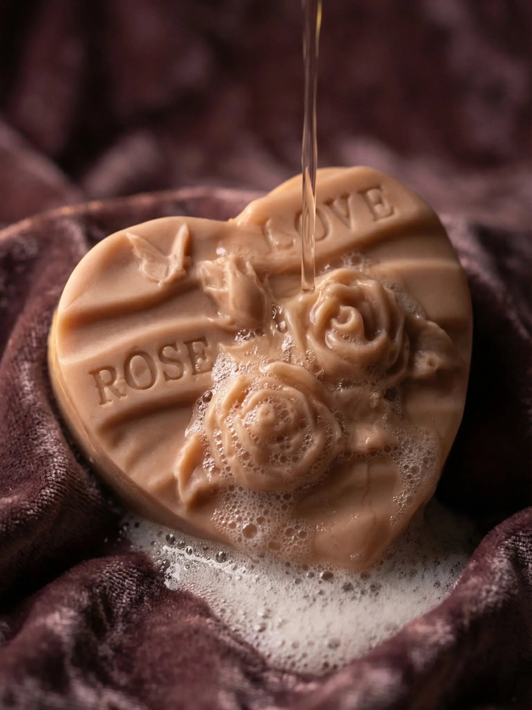 Rosélia sculpted rose heart soap resting on velvet fabric, luxury Valentine’s Day soap with organic olive oil, rose geranium and vanilla.