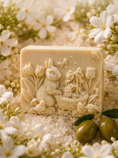 Luxury jasmine olive oil soap with bunny design, surrounded by white jasmine flowers and green olives, natural skincare by DEOS Co.