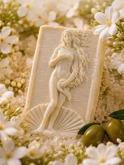 Aphrodite Anadyomene jasmine olive oil soap surrounded by jasmine flowers and green olives, luxury natural soap DEOS Co.