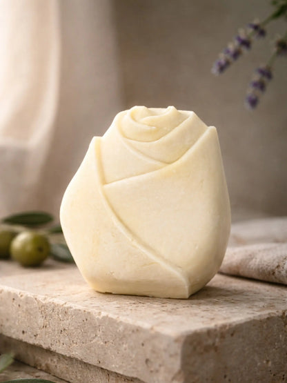 Handcrafted olive oil lavender soap shaped like a rose bud, displayed on natural stone by DEOS CO. - The Bud