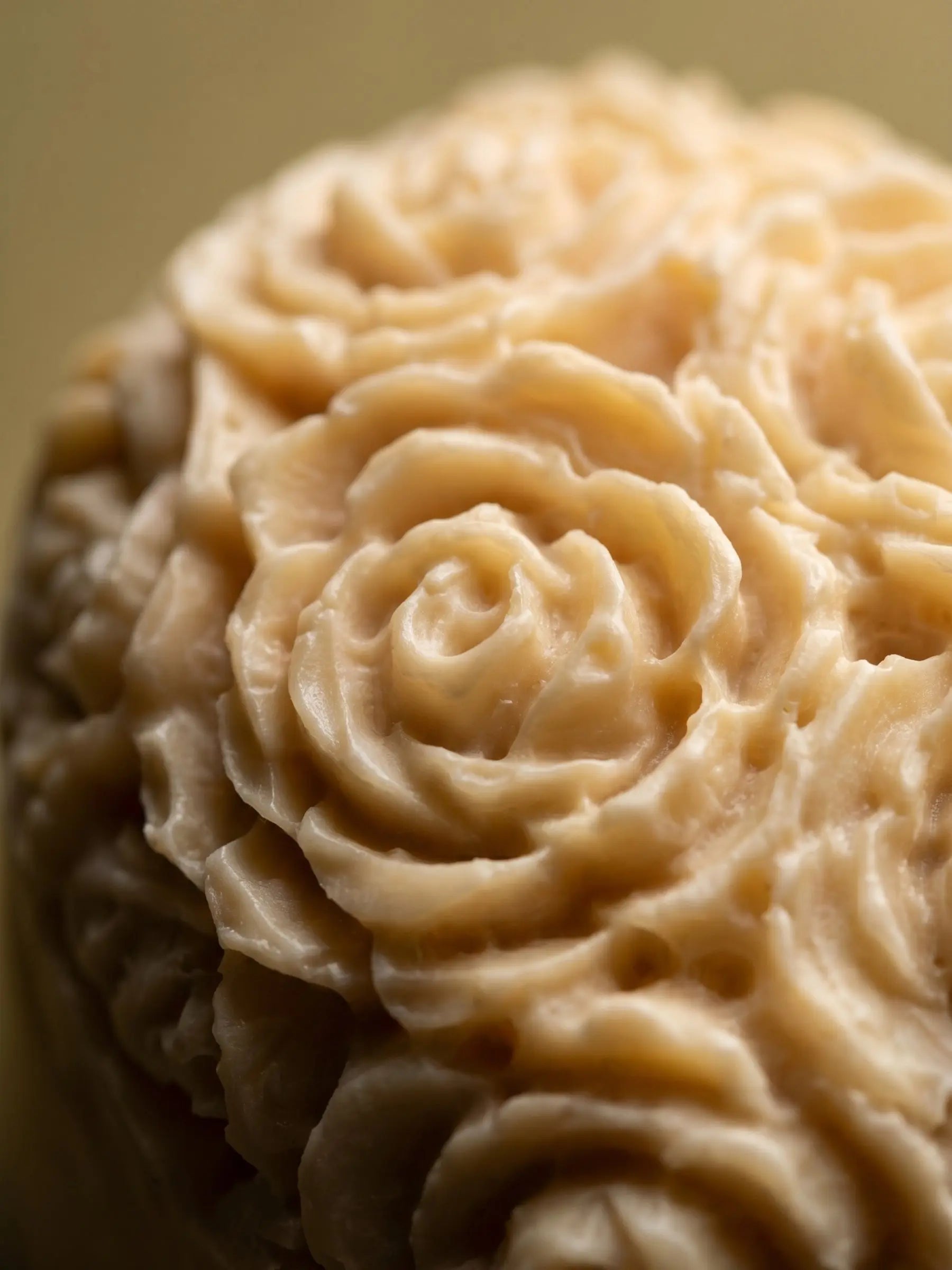 Close-up of rose floral texture on jasmine olive oil heart soap, handcrafted luxury soap by DEOS Co.