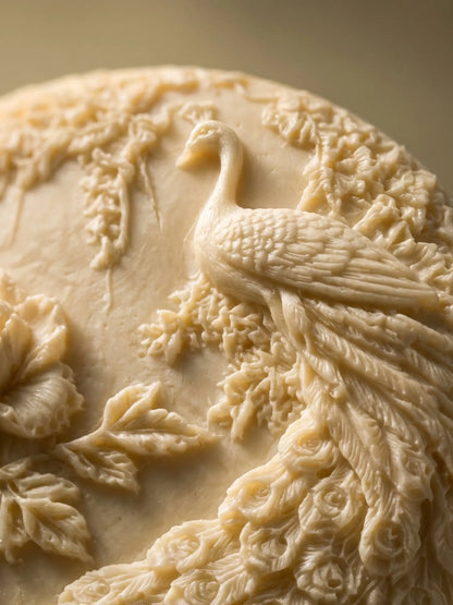 Close-up of peacock relief on jasmine olive oil soap, detailed handcrafted luxury soap by DEOS Co.