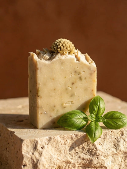 Luxury basil soap with olive oil on travertine stone, natural herbal exfoliating bar soap for glowing skin, premium botanical skincare